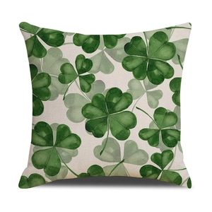 Square beige linen pillow cover with green watercolor clover print on white background