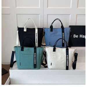 Four colorful canvas lunch bags with contrast handles and detachable shoulder straps