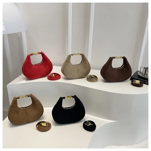 Detailed display of five colorful suede half-moon handbags with elegant gold metal buckles