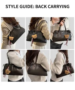 Detail view of black PU tote bag showing fashion lettering and plush bear accessory