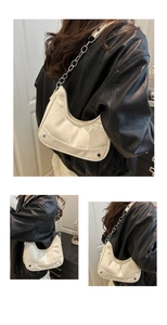 Detail of white moon hobo bag with silver chain strap and metal rivet accents