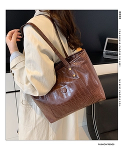Brown crocodile embossed tote bag styled as a large shoulder bag for commuting