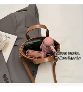Internal view of brown bucket bag showing umbrella, phone, and wallet storage