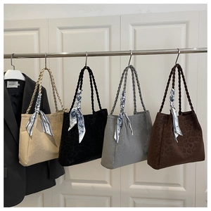Detail of four leopard print tote bags in beige, black, gray and brown with woven handles