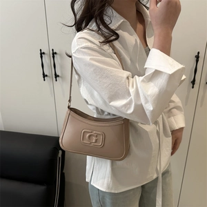 Fashionable beige underarm bag with embossed G logo and elegant shoulder strap design