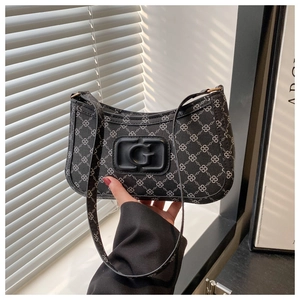 Detail of the black hobo bag showing the geometric clover pattern and 3D G logo