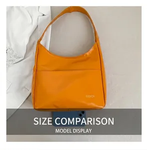 Detailed top view of a yellow PU leather shoulder bag with a smartphone for size comparison
