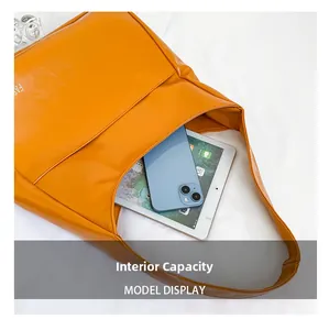 Internal capacity of yellow tote bag showing space for tablet and smartphone