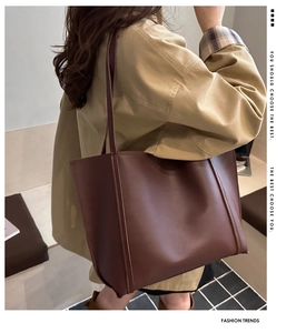 Close-up of deep brown tote bag with high-quality leather texture on shoulder