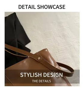 Close-up of brown glossy leather tote bag showing fine stitching and rivet detail