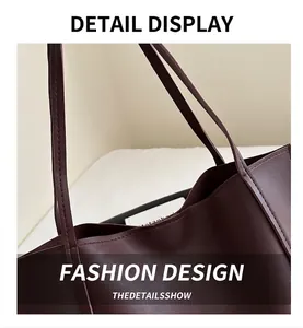 Close-up of premium dark burgundy leather tote bag with fine stitching and slim straps