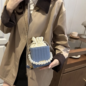 Elegant blue woven mini bucket bag with pearl handle and drawstring lining for women