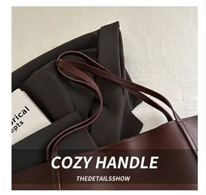Detail shot of the comfortable brown leather handle on a vintage tote bag