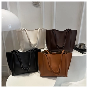 Minimalist large tote bags in white, black, and brown smooth faux leather shown in a row