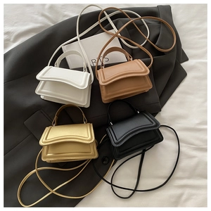 Flat lay of small crossbody square bags in white, brown, gold, and black leather textures