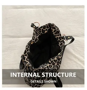 Detailed view of leopard print tote bag interior with black lining and durable straps