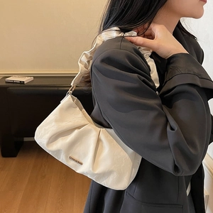 Chic white pleated crossbody bag with stylish chain and metal logo plate for modern women