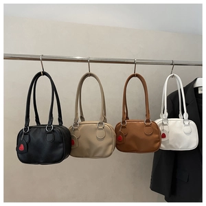 Detailed view of vintage bowling bags in black, beige, coffee, and white leather finishes