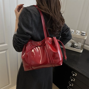 Glossy red PU leather tote bag with bow detail and large capacity shown on model