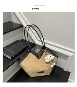 Detailed view of brown corduroy tote bag with black leather straps and cloud charm