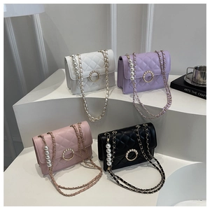 Detailed view of quilted leather mini bags with pearl chain straps in four elegant colors