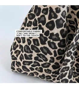 Close-up of leopard print shoulder bag made of thick canvas fabric on an office desk