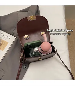 Interior view of the dark brown saddle bag showing capacity for phone and perfume