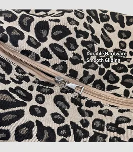 Close-up of leopard jacquard fabric and smooth silver metal zipper on the shoulder bag