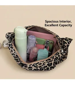 Spacious interior of leopard print hobo bag showing water bottle, tablet and cosmetics