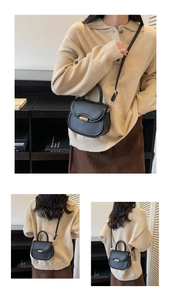 Detail view of the black matte saddle bag with a golden cylindrical twist lock
