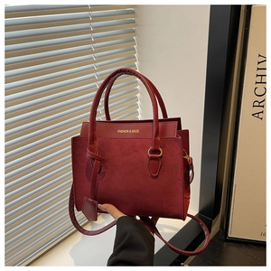 Detail of dark red paneled tote bag featuring suede texture and FASHION & BAGS lettering