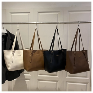 Detailed row of tote bags in cream, tan, black and brown for daily commuting usage