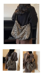 Detailed view of large leopard print shoulder bag with soft canvas texture and drape