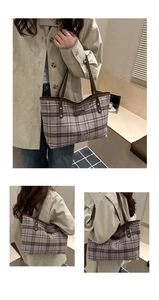 Detail of vintage plaid tote bag featuring brown leather straps and wool texture
