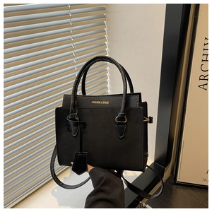 Detail of black matte crossbody bag with gold Fashion & Bags lettering and hardware