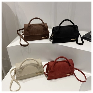 Detailed view of four textured crossbody bags in dark brown black cream and rust red colors