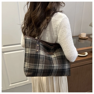 Detail showing the vintage plaid pattern and premium texture of the large tote bag