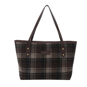 Vintage checkered tote bag in brown and black tones with leather handles and gold studs