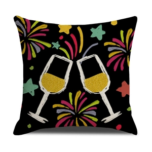 Detail of square black pillow cover with champagne glasses and colorful firework print