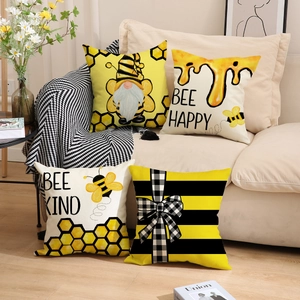Set of 4 bee themed decorative pillow covers with gnome and honey patterns on sofa