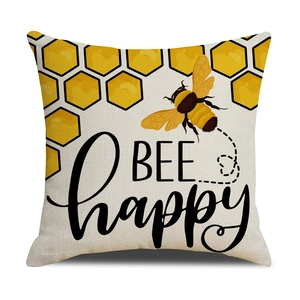 Macro detail of Nordic linen pillow cover featuring BEE happy print and honey bee design