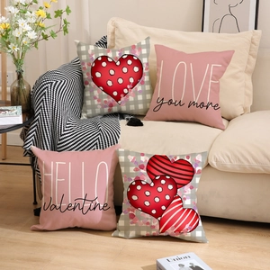 Detailed view of Valentine's Day pillow covers with heart patterns on a soft white sofa