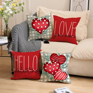 Close-up of Valentine's Day pillow covers with red hearts and festive LOVE typography