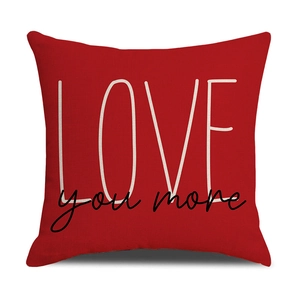 Close-up of red LOVE you more printed linen pillowcase with modern lettering detail