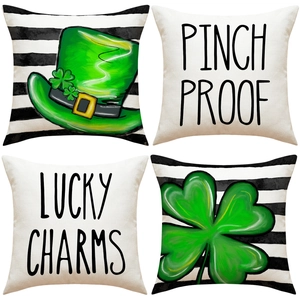 Detail of four St. Patrick's Day cushion covers with green clovers and striped patterns