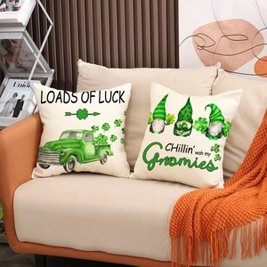 St. Patrick's Day shamrock and gnomes pillow covers set on a cozy orange sofa