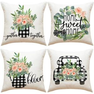 Detail of four linen pillow covers featuring farmhouse floral prints and plaid accents