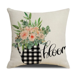 Macro detail of linen pillow cover with pink flowers and black cursive bloom text