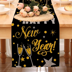 Detail of Happy New Year table runner with gold glitter dots and champagne graphics