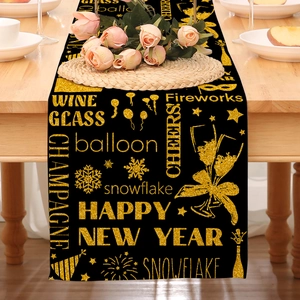 Detail of Happy New Year table runner with gold glitter prints on black linen fabric